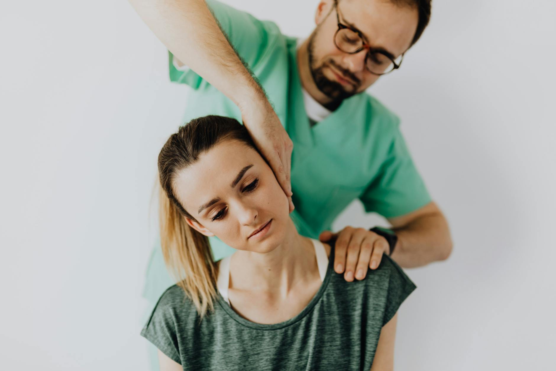 Professional chiropractor treating a woman's neck pain with therapeutic techniques.